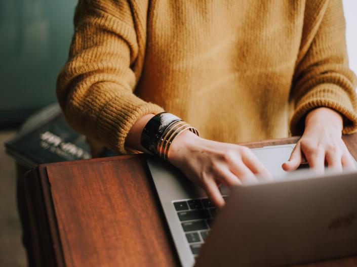 woman typing on laptop